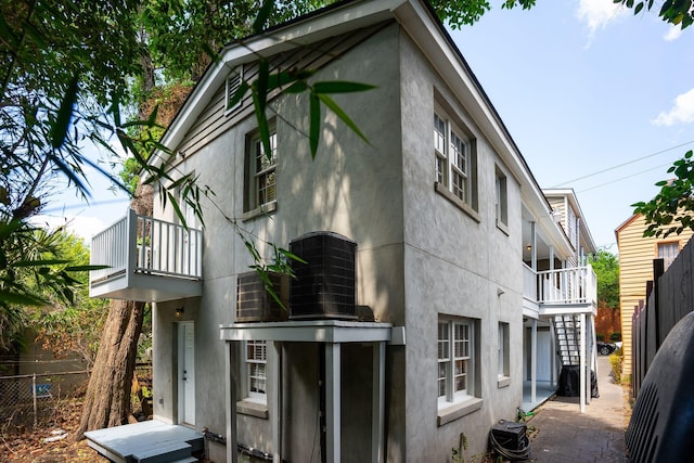 87 America St Unit A, B, C, Charleston, SC 29403 - view of side of property with a balcony, stucco siding, fence, and central AC