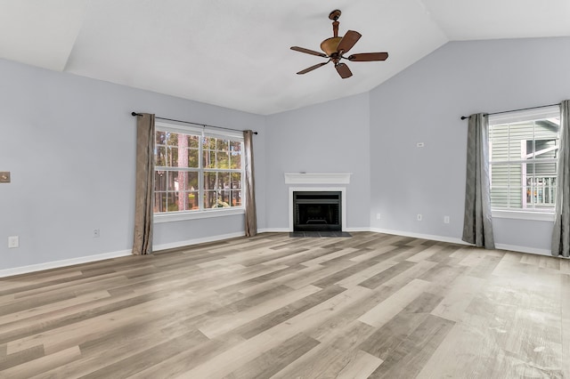 unfurnished living room with light wood-type flooring, vaulted ceiling, and ceiling fan