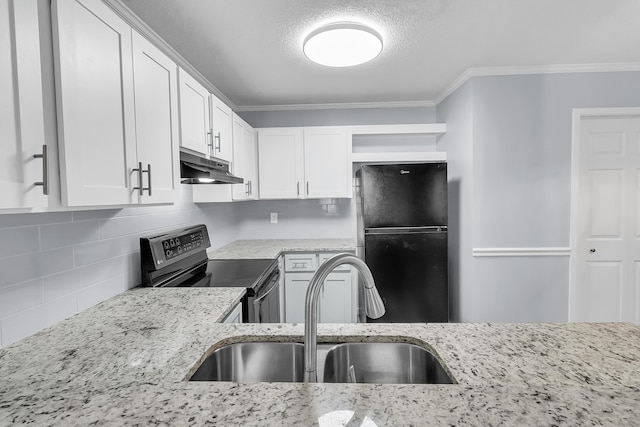 kitchen with decorative backsplash, light stone counters, sink, black appliances, and white cabinetry