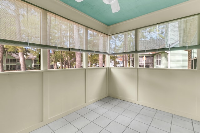 unfurnished sunroom with ceiling fan