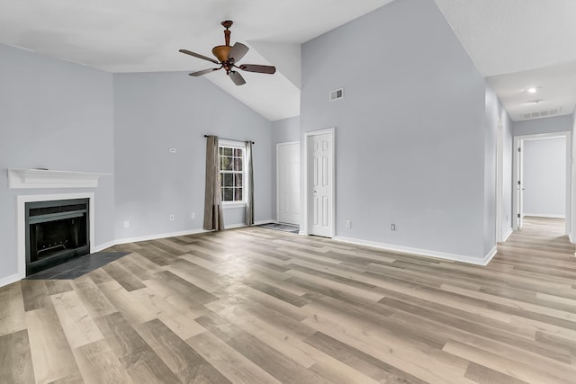 unfurnished living room with ceiling fan, high vaulted ceiling, and light hardwood / wood-style floors