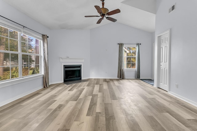 unfurnished living room featuring ceiling fan, light wood-type flooring, and vaulted ceiling