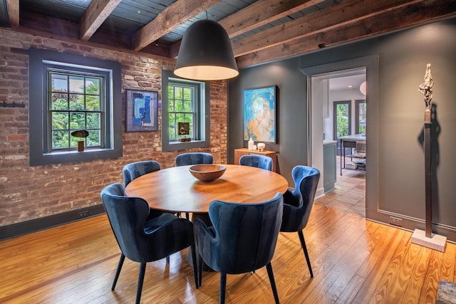 dining area featuring baseboards, beamed ceiling, wood-type flooring, and wooden ceiling