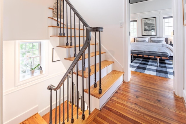 stairs featuring wood finished floors