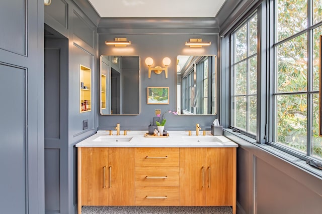 bathroom featuring healthy amount of natural light and double vanity
