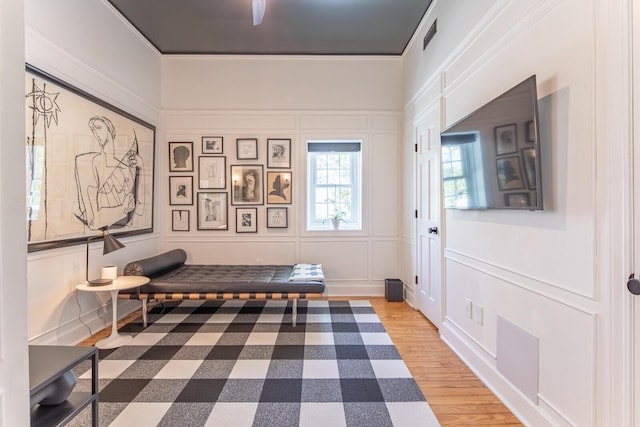 foyer entrance featuring a decorative wall and wood finished floors