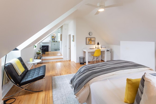 bedroom with wood finished floors and vaulted ceiling