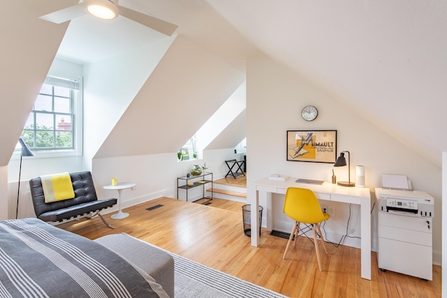 office featuring wood finished floors, vaulted ceiling, ceiling fan, and baseboards