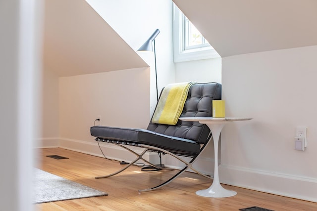 sitting room with wood finished floors and baseboards