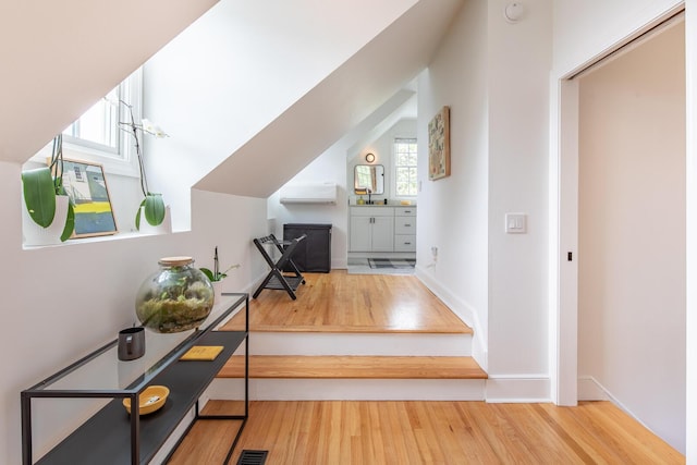 hallway featuring wood finished floors and baseboards