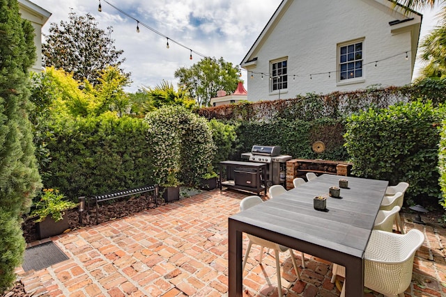 view of patio / terrace with a fenced backyard and a grill