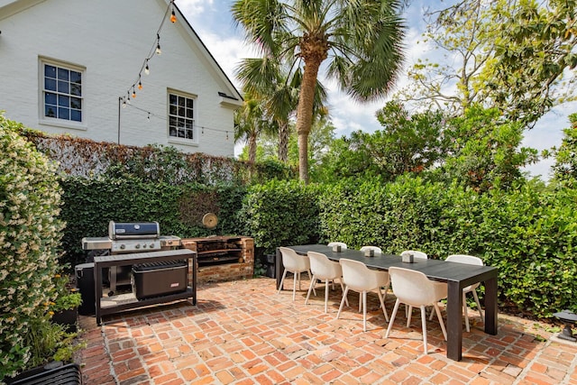 view of patio / terrace with outdoor dining space and a grill