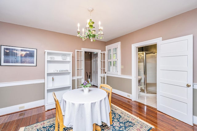 dining space with a notable chandelier and light wood-type flooring