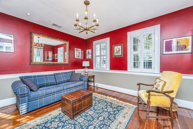 living room with a notable chandelier and hardwood / wood-style flooring