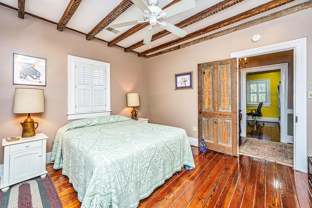 bedroom with beamed ceiling, dark wood-type flooring, and ceiling fan