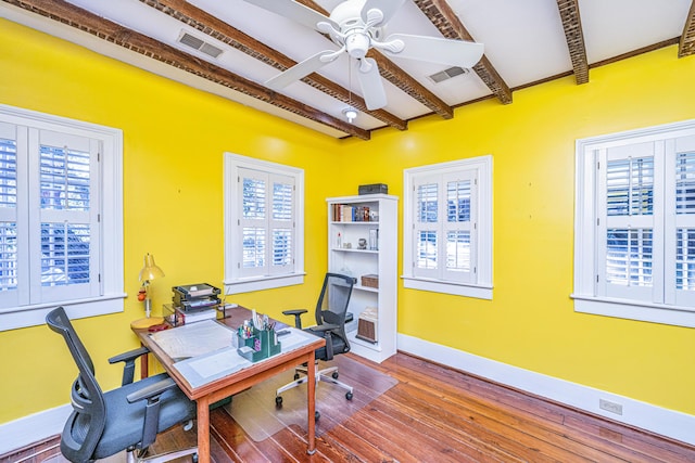 home office with beamed ceiling, ceiling fan, a healthy amount of sunlight, and hardwood / wood-style floors