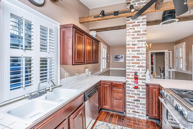 kitchen with appliances with stainless steel finishes, tile counters, dark hardwood / wood-style flooring, and beam ceiling