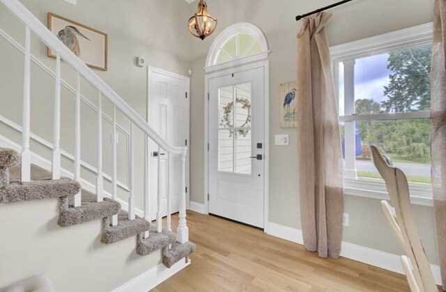 16 Oatly Cir, Charleston, SC 29414 - foyer entrance featuring stairway, light wood finished floors, a chandelier, and baseboards