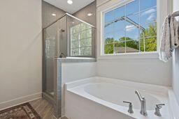 bathroom with wood finished floors, a shower stall, a bath, and recessed lighting