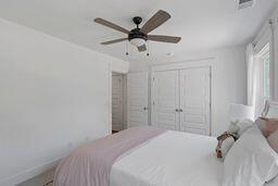 bedroom featuring a ceiling fan, a closet, visible vents, and baseboards