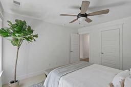 bedroom with ceiling fan and visible vents