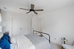 bedroom with ceiling fan and a closet