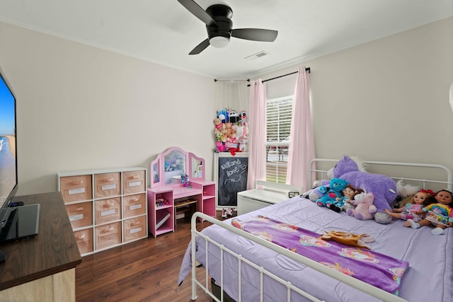 bedroom with ornamental molding, dark hardwood / wood-style floors, and ceiling fan