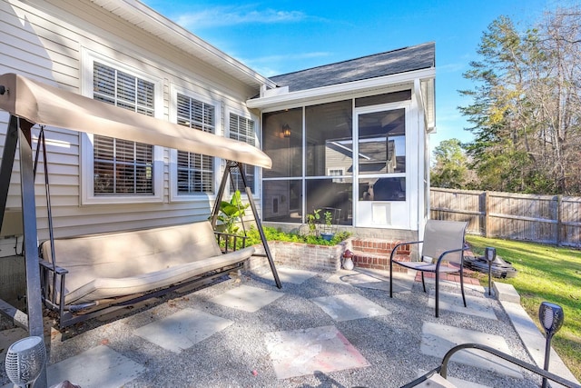 view of patio featuring a sunroom