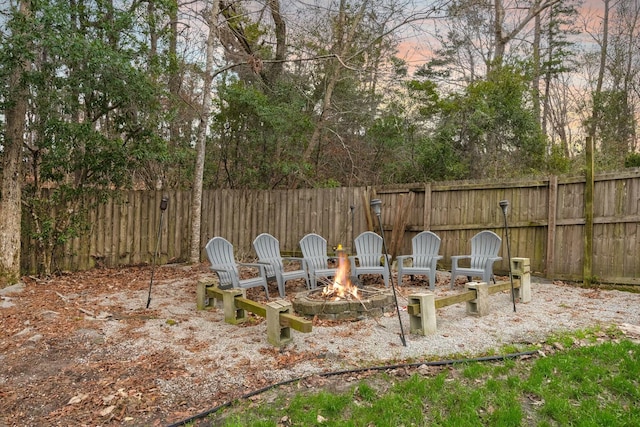 patio terrace at dusk featuring a fire pit