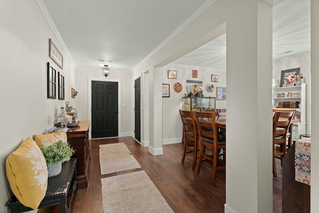 entrance foyer with dark hardwood / wood-style flooring and ornamental molding