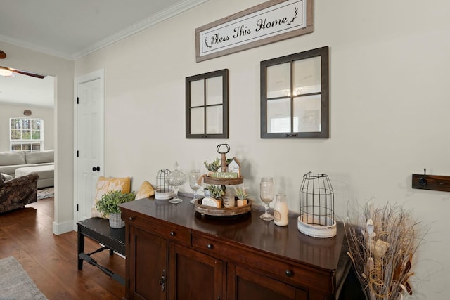 interior space with ornamental molding and dark wood-type flooring