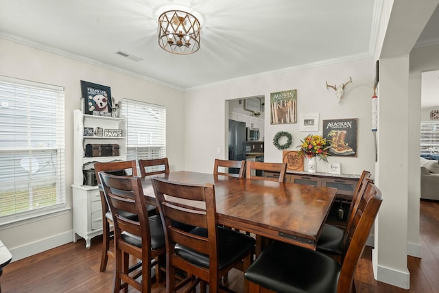 dining room featuring ornamental molding, dark hardwood / wood-style floors, and a chandelier