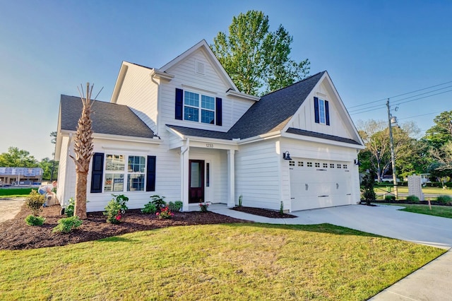 view of front of property with driveway, a shingled roof, and a front yard