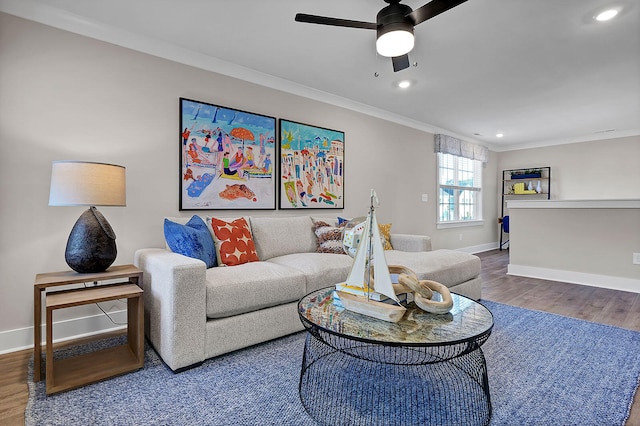 living area with baseboards, ornamental molding, wood finished floors, and recessed lighting