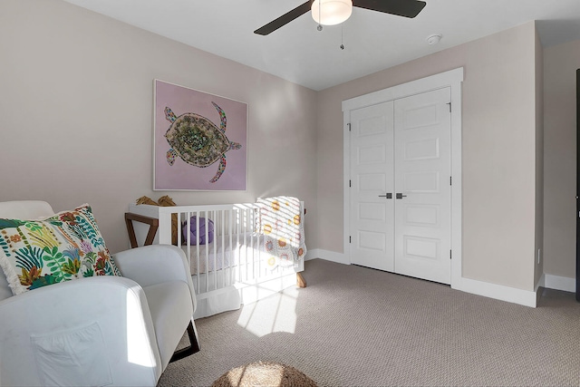 carpeted bedroom with a closet, ceiling fan, and baseboards