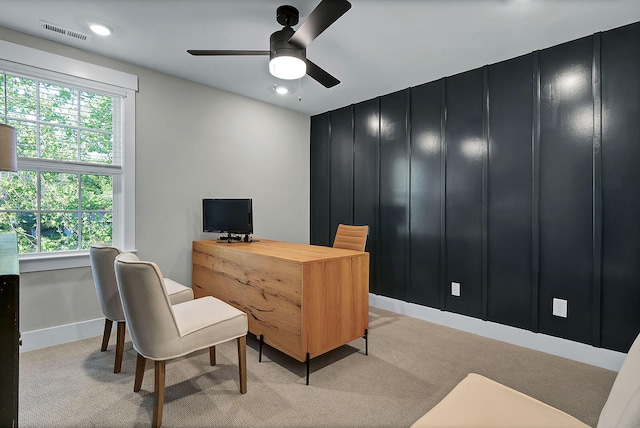 office featuring visible vents, plenty of natural light, light carpet, and ceiling fan