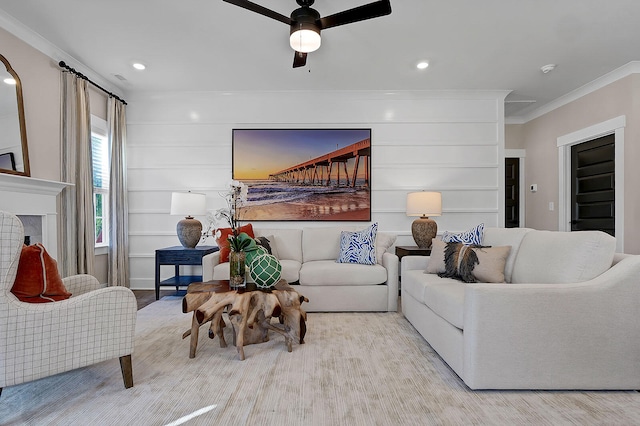 living room featuring a ceiling fan, a tile fireplace, crown molding, built in shelves, and recessed lighting