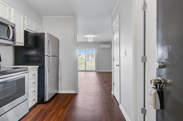 259 E Bay St Unit 7C, Charleston, SC 29401 - kitchen featuring stainless steel appliances, dark wood-type flooring, white cabinetry, a wall mounted AC, and baseboards