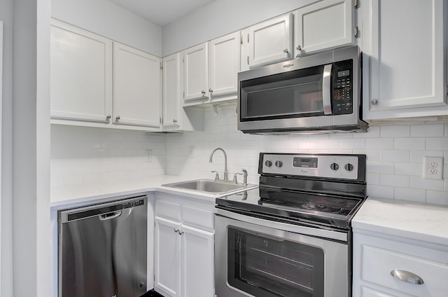 259 E Bay St Unit 7C, Charleston, SC 29401 - kitchen featuring stainless steel appliances, a sink, white cabinetry, and backsplash