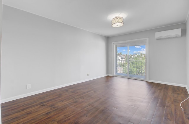 259 E Bay St Unit 7C, Charleston, SC 29401 - spare room featuring an AC wall unit, baseboards, and dark wood-style floors
