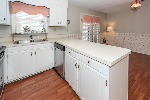 kitchen with a wealth of natural light, dishwasher, a peninsula, and a sink