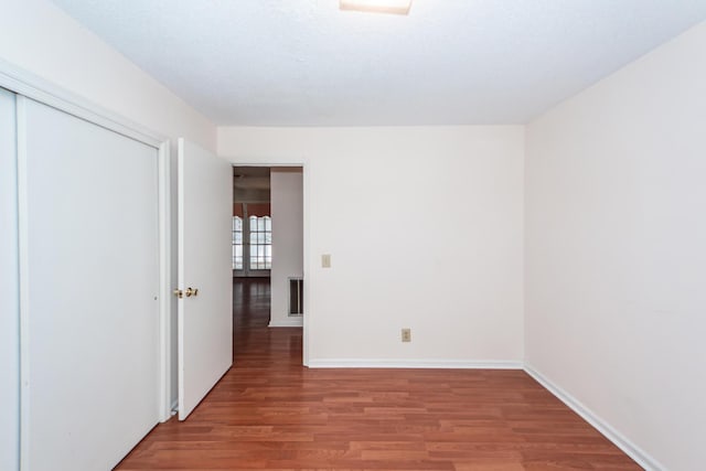 spare room with light wood finished floors and baseboards