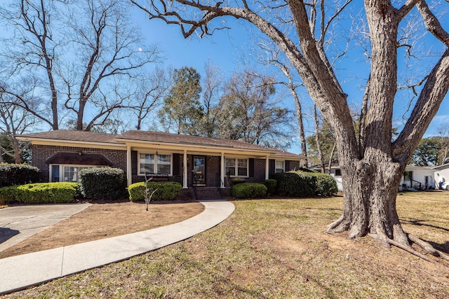 single story home with a front lawn and brick siding