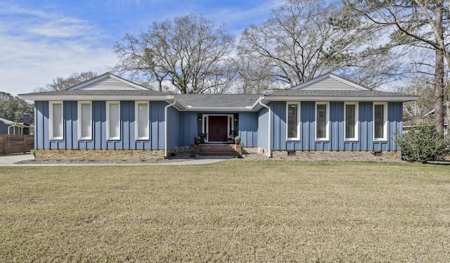 view of front facade featuring a shingled roof, crawl space, a front yard, and board and batten siding