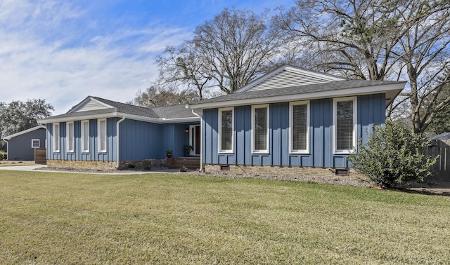 view of front facade with crawl space, a shingled roof, a front lawn, and board and batten siding