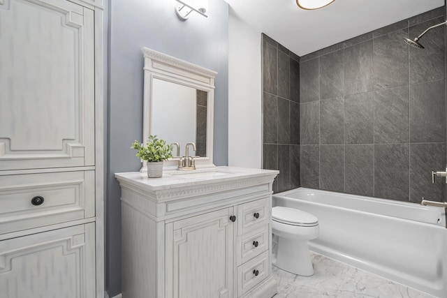 bathroom featuring marble finish floor, bathing tub / shower combination, toilet, and vanity