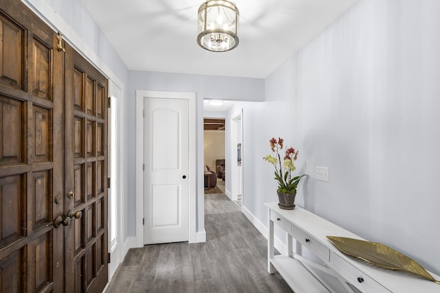 hall featuring wood finished floors and baseboards