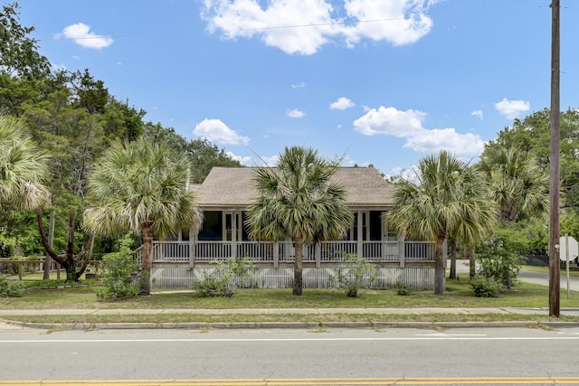 view of front of home featuring covered porch and roof with shingles