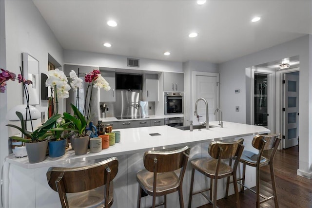 1481 Center Street Ext Unit 1102, Mount Pleasant, SC 29464 - kitchen with light countertops, a kitchen breakfast bar, dark wood-style flooring, recessed lighting, and a peninsula