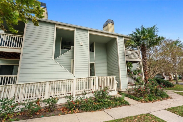 1481 Center Street Ext Unit 1102, Mount Pleasant, SC 29464 - view of property exterior with a chimney and a porch